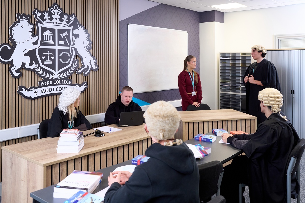 A Level Law students in robes and wigs act out a mock trial in the Moot Court