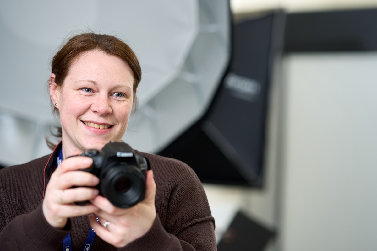 A student points a camera Photography