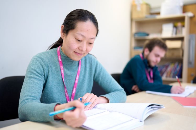 A student reads through her work