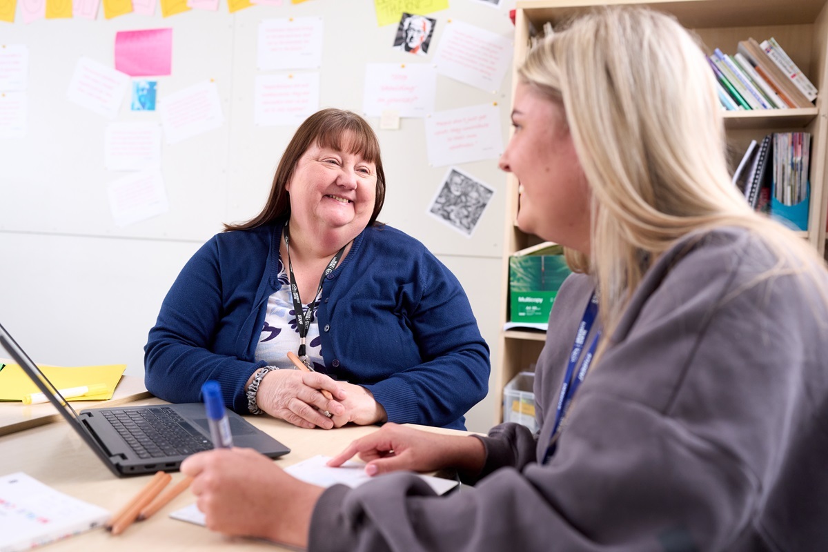 A student smiles at a tutor Childrens Development