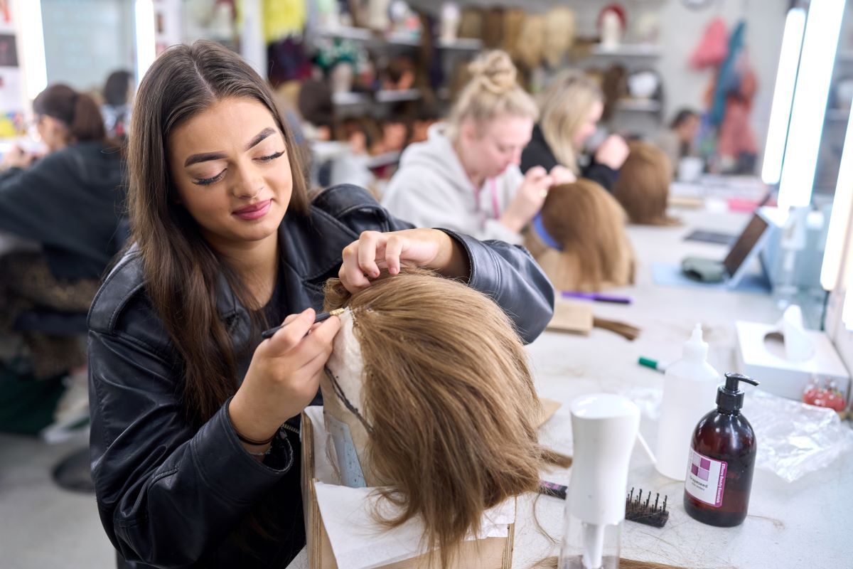 A student works on a wig Media Make up