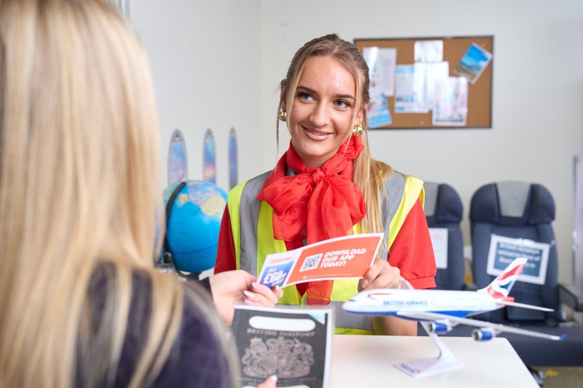 A travel tourism student role playing a check in