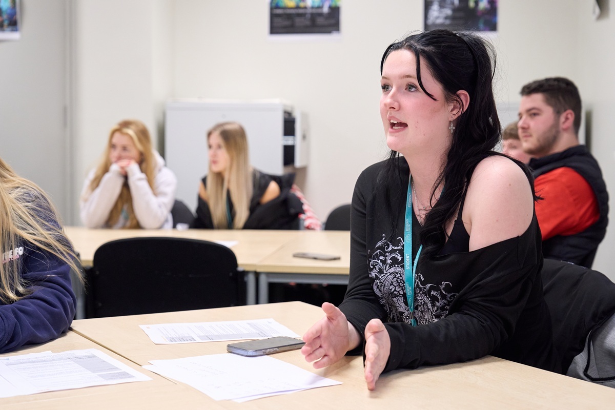 A vocational Uniformed Services student is speaking in a classroom discussion