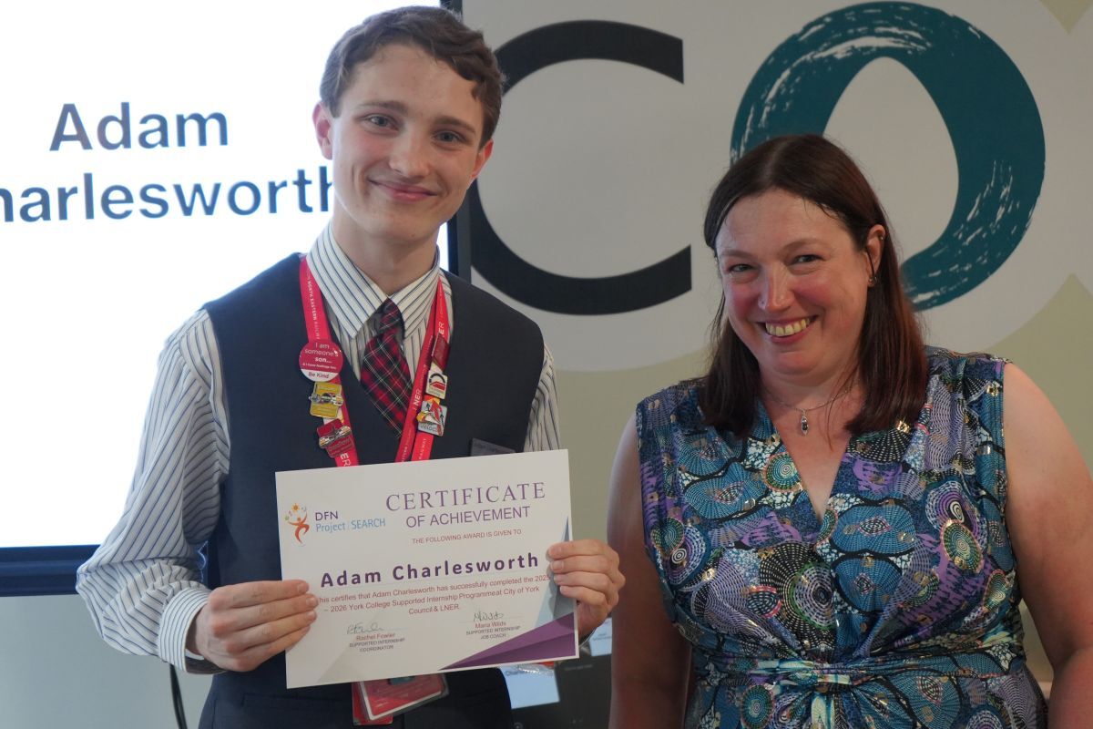 Adam Charlesworth receiving his Supported Internship certifcate from Rachel Fowler