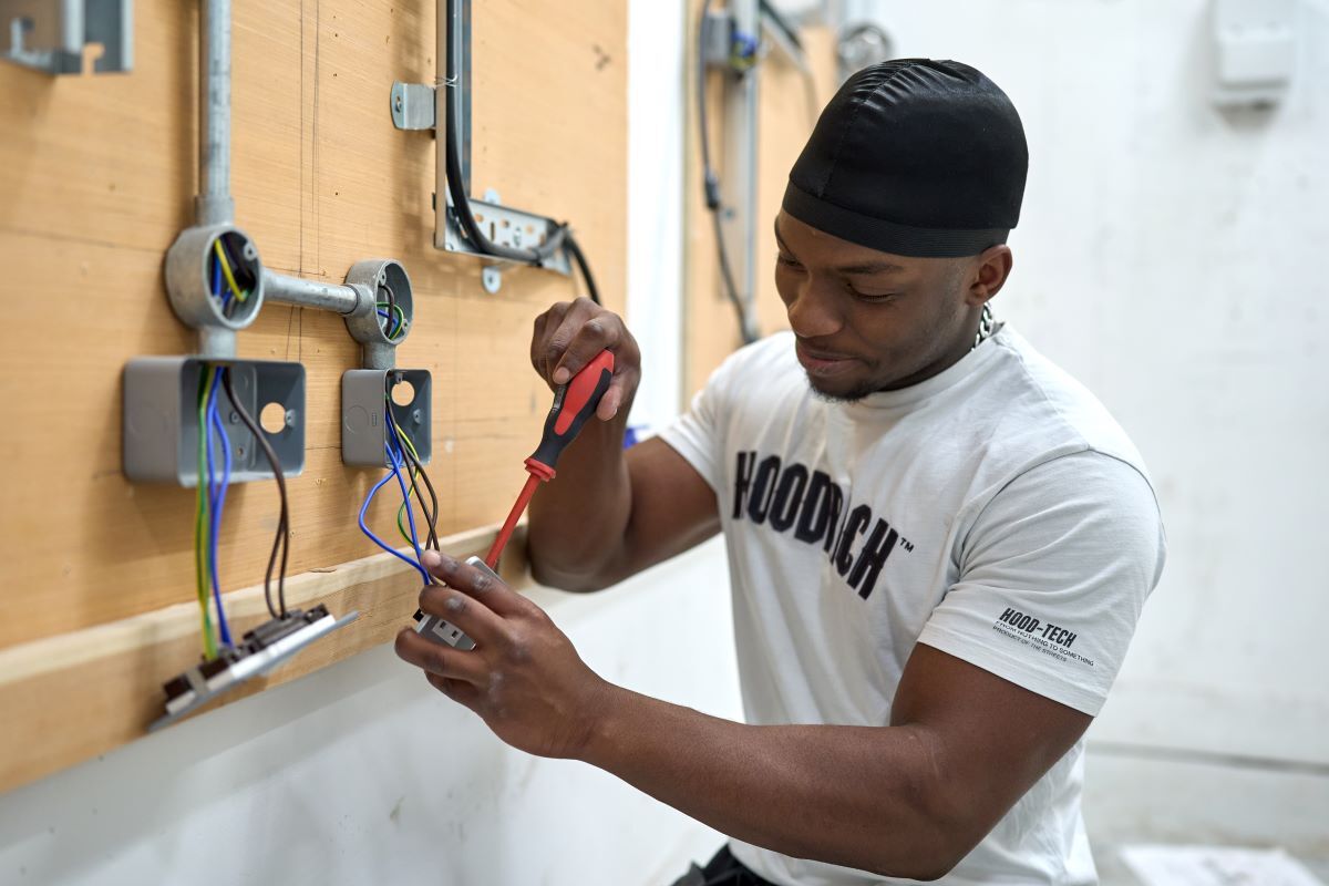 An Electrical student wires a socket Apprenticeships
