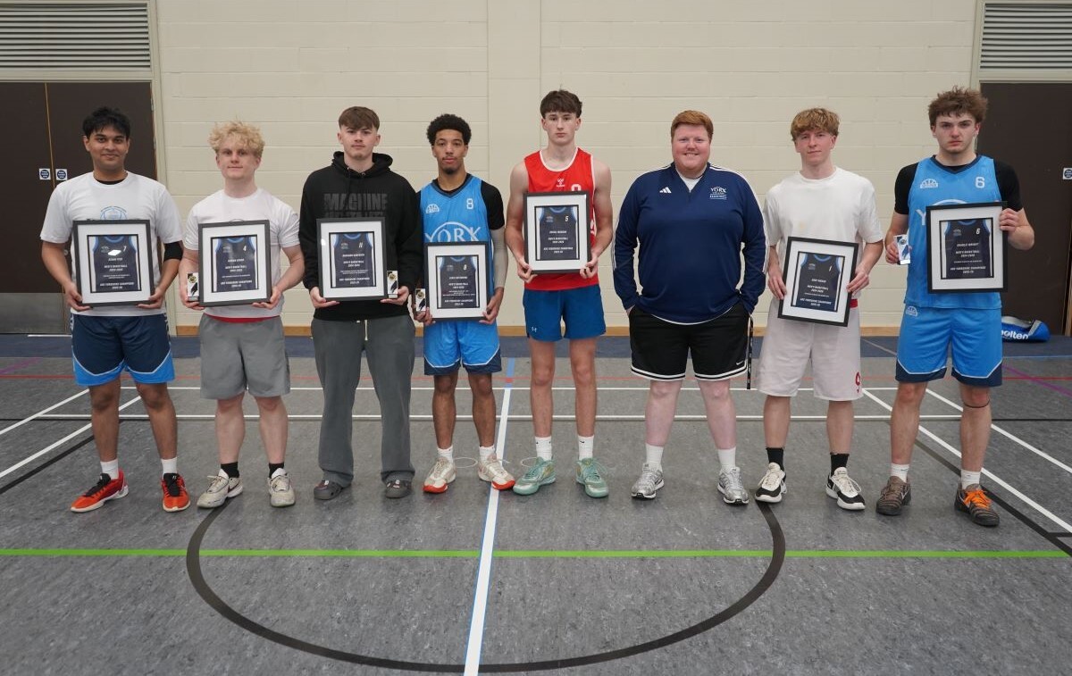Azaan Iyer stands on the far left with his final year team mates and coach Tyler Paton Pottage with the team holding their framed shirts