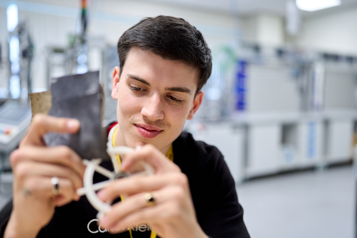 student_sanding_miniature_wheel_in_engineering