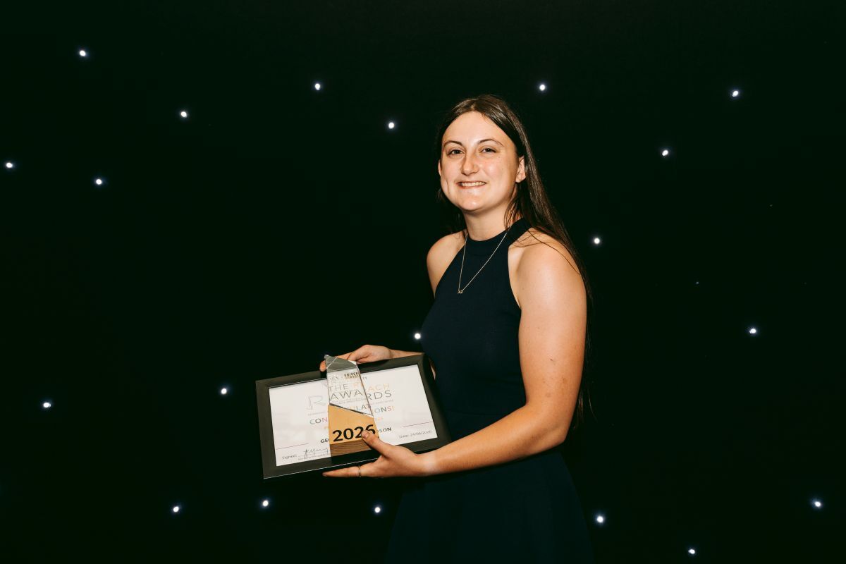 Georgina Richardson smiling with her REACH Award and certificate