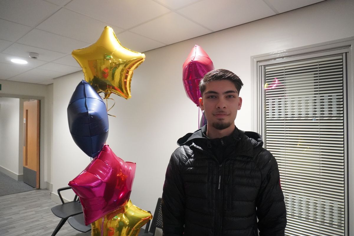 Hamad Sajjad Ahmed celebrates his GCSE result with star shaped balloons