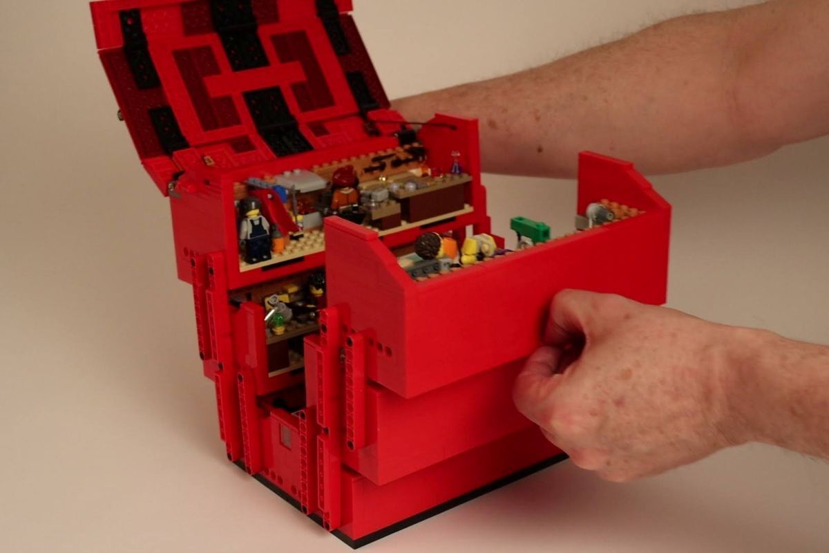 Hand opens toolbox showing a couple of workshops