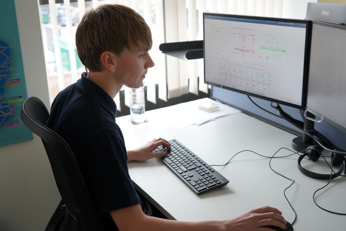 Jackson Hall works on Computer Aided Design at his desk in AGH Engineerings office