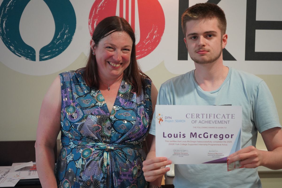 Louis Mc Gregor receiving his Supported Internship certifcate from Rachel Fowler