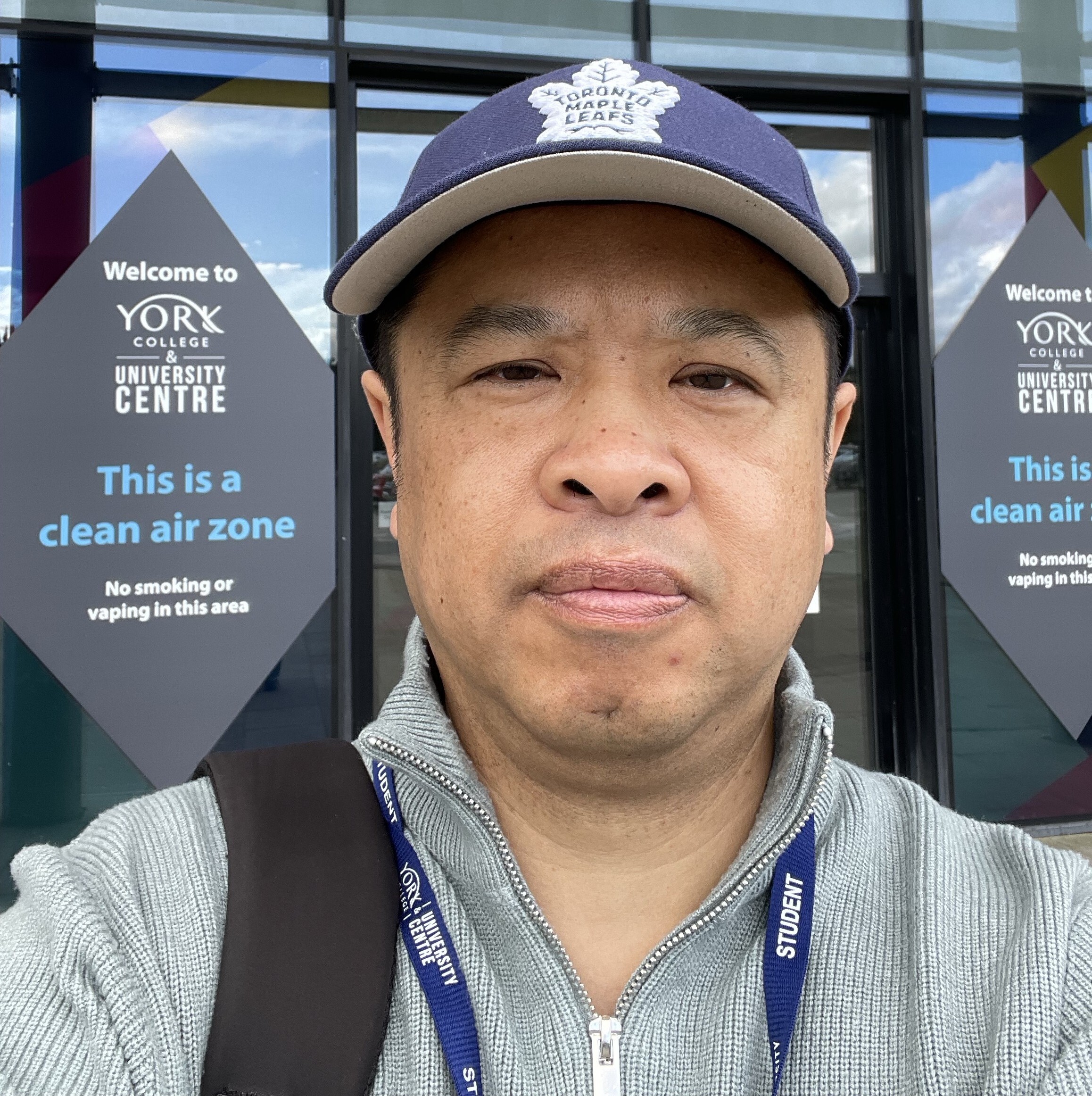 Mao Chen selfie picture in front of York Colleges main entrance
