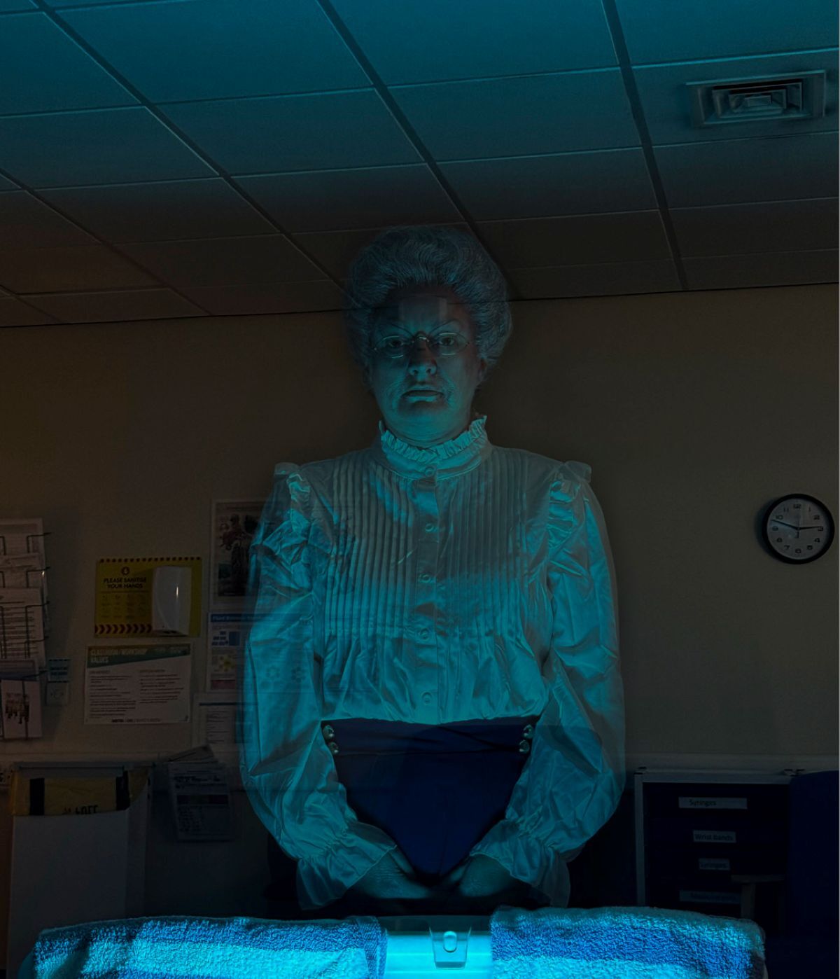 Old woman appearing as a ghost at the end of a bed