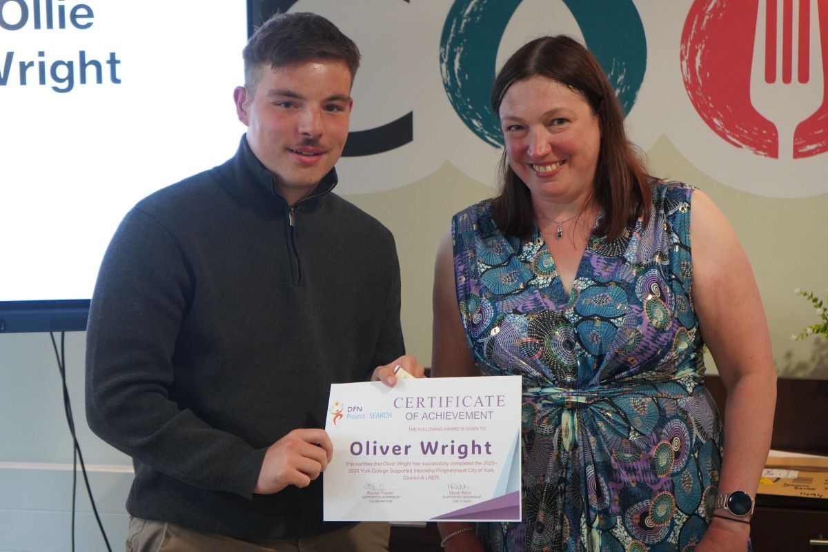 Ollie Wright receiving his Supported Internship certifcate from Rachel Fowler