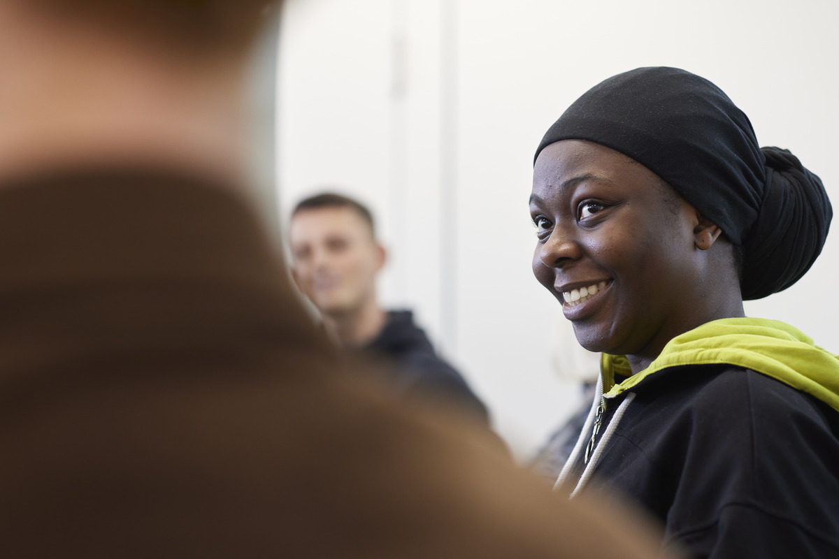 One student smiles at another Level 3 Counselling