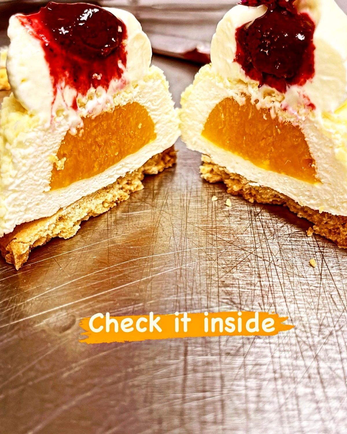 Passion fruit mango and coconut mousse cut in half to show mango filling
