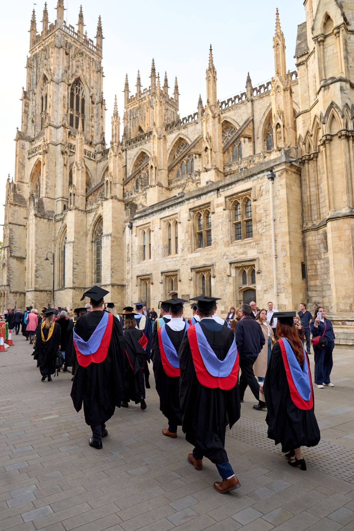 Robyn Bradley and other Engineering graduates pictured from behind as they approach York Minster