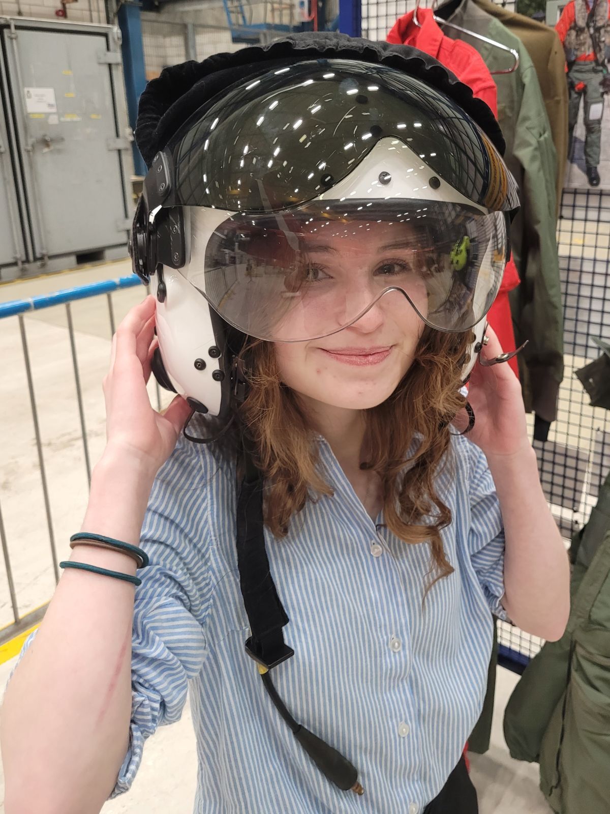 Robyn Bradley tries on a white Red Arrows helmet