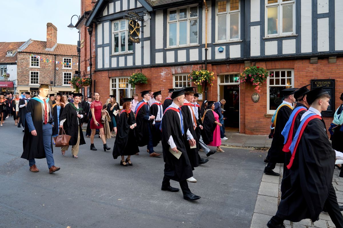 Robyn Bradley walking from the Merchant Taylors Hall to York Minster with fellow graduates in their gowns