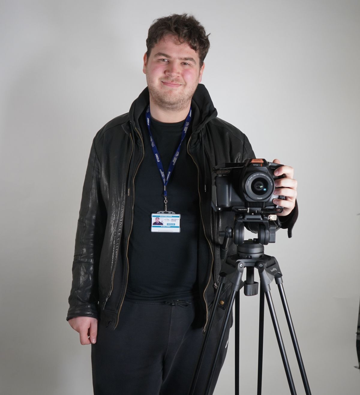 Sam Matten poses with camera on tripod