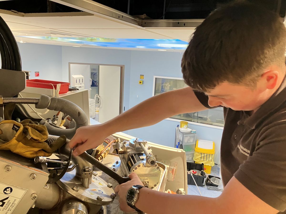 Sam Welch using a spanner on machinery