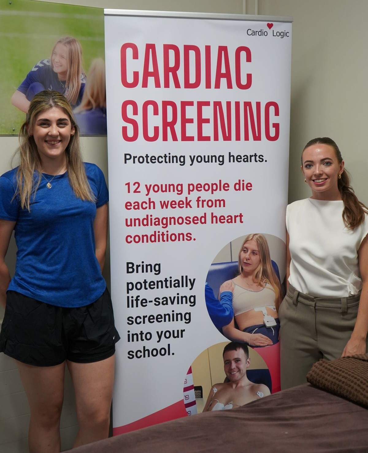 Sports tutor Emma Palmer and Cardio Logics Faye Singleton standing either side of a Cardio Logoc banner