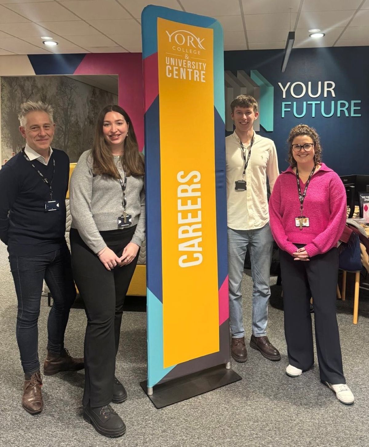 The Careers Enterprise team standing next to a banner
