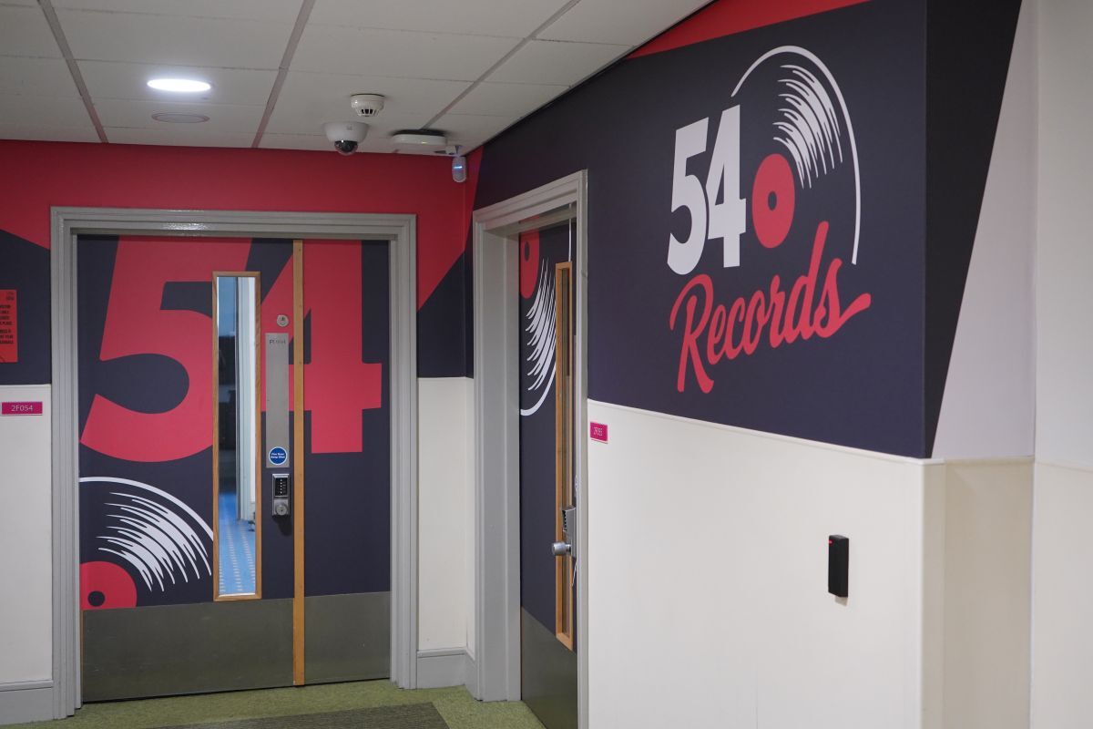 The branded corridor and door of the 54 Records studio