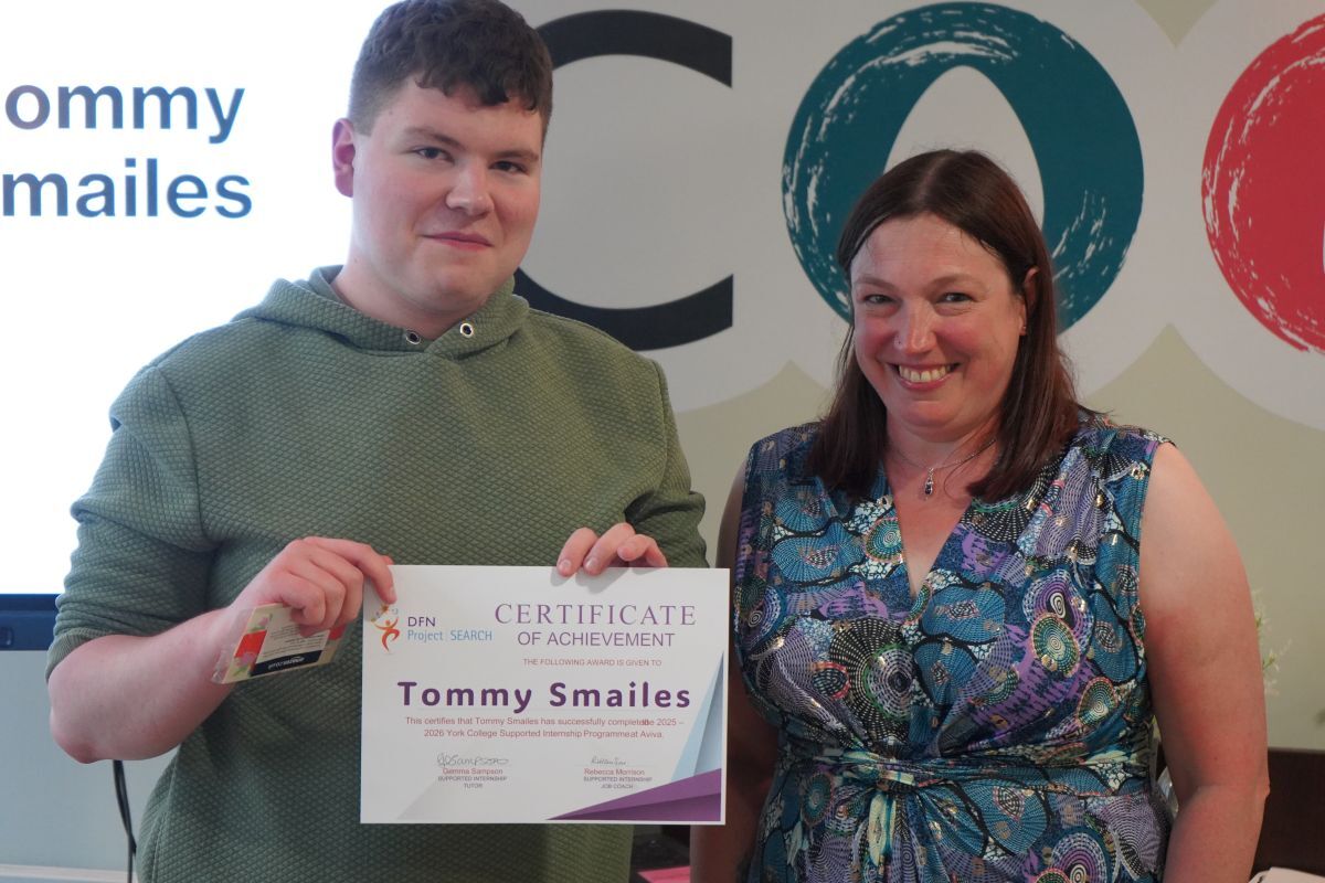 Tommy Smailes receiving his Supported Internship certifcate from Rachel Fowler