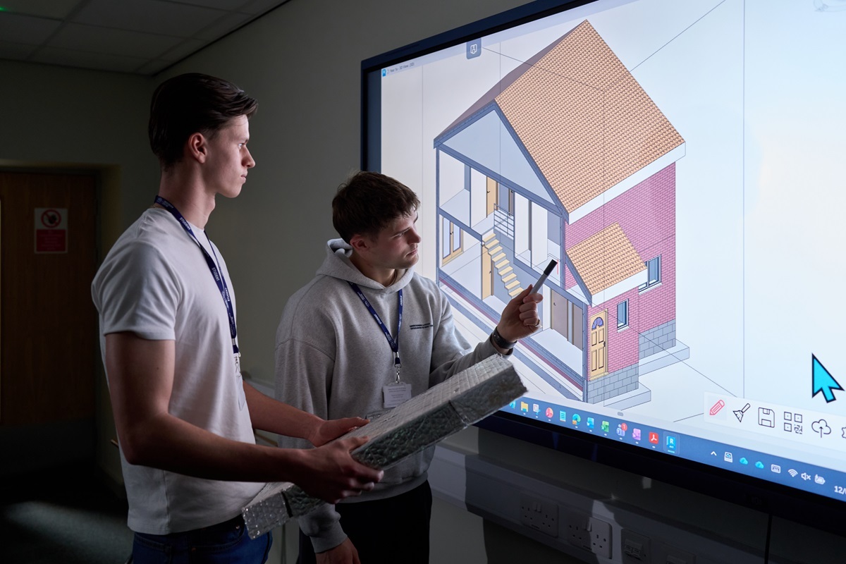 Two students look at an architectural drawing Construction