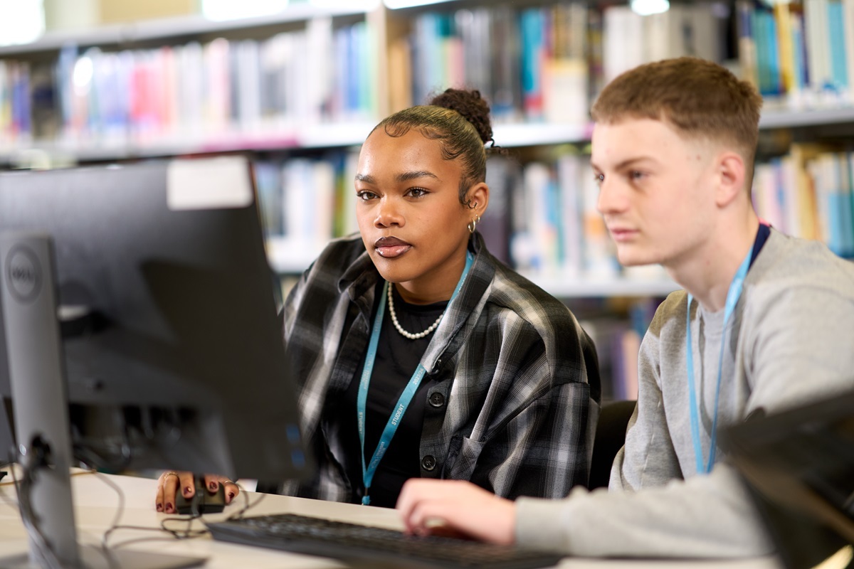 Two students looking at a computer screen in the learning centre