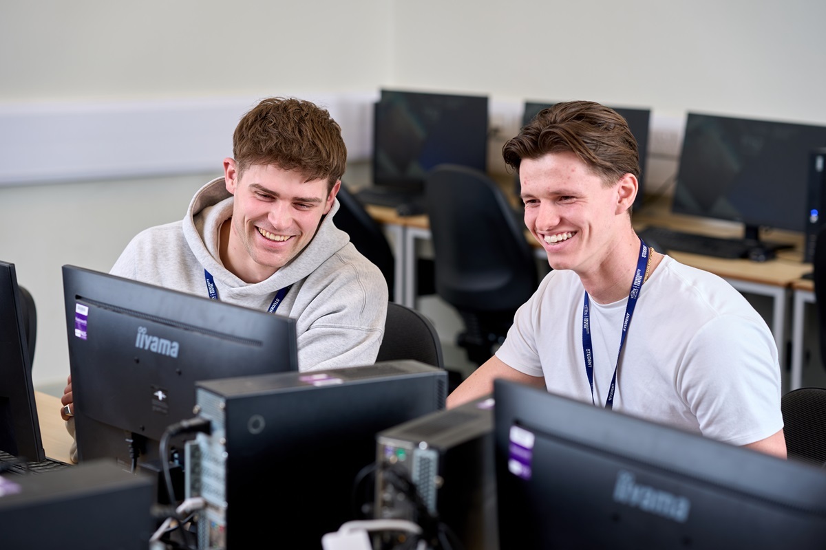 Two students work on a computer Construction