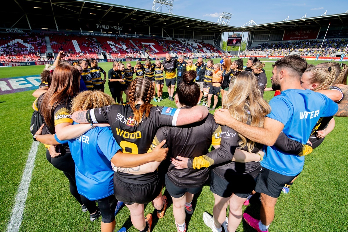 York City RLFC players are in a team huddle on the pitch