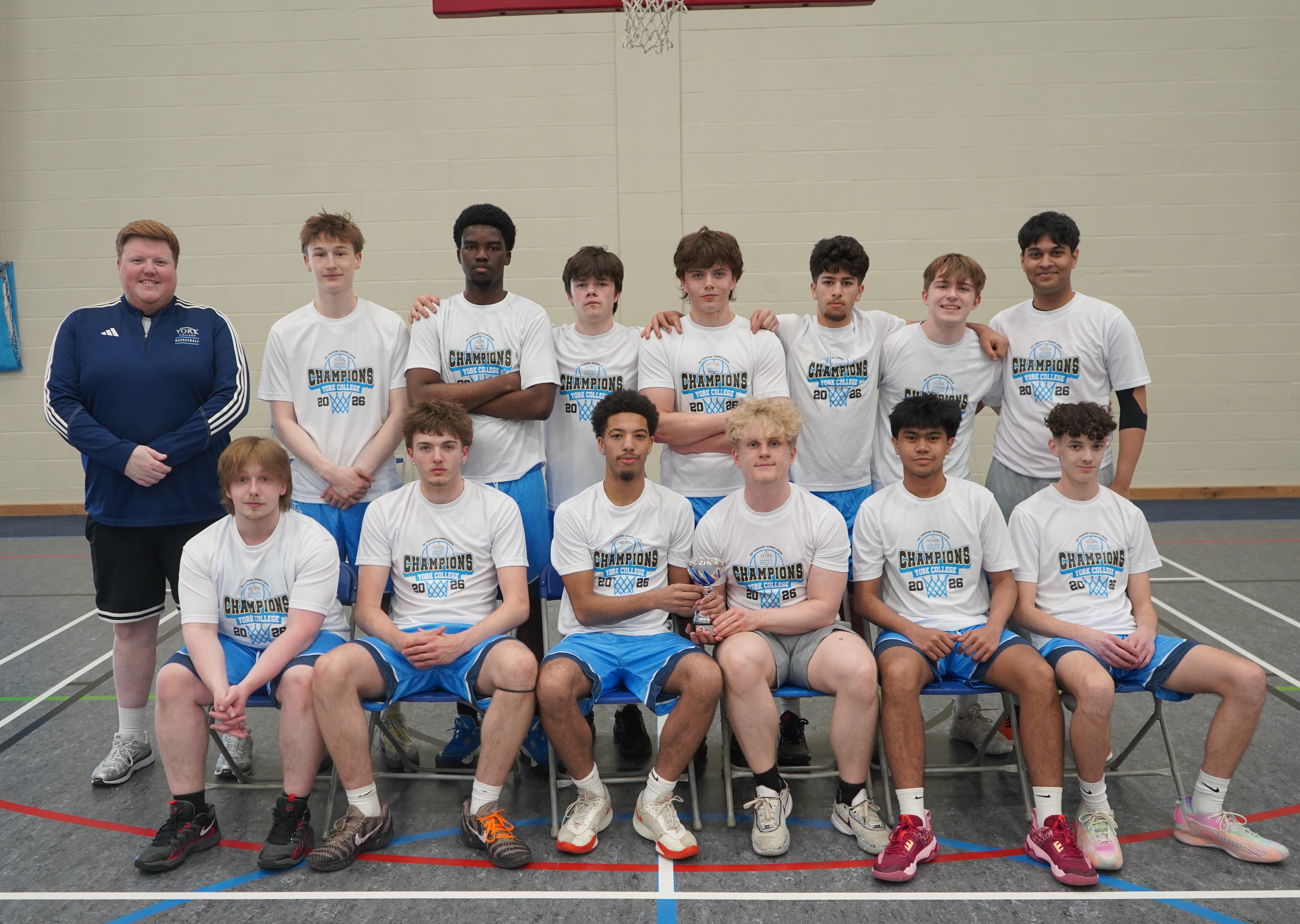 York Colleges Basketball Team picture with the Association of Colleges Yorkshire Humber Mens League Two trophy with Azaan Iyer back row furthest left