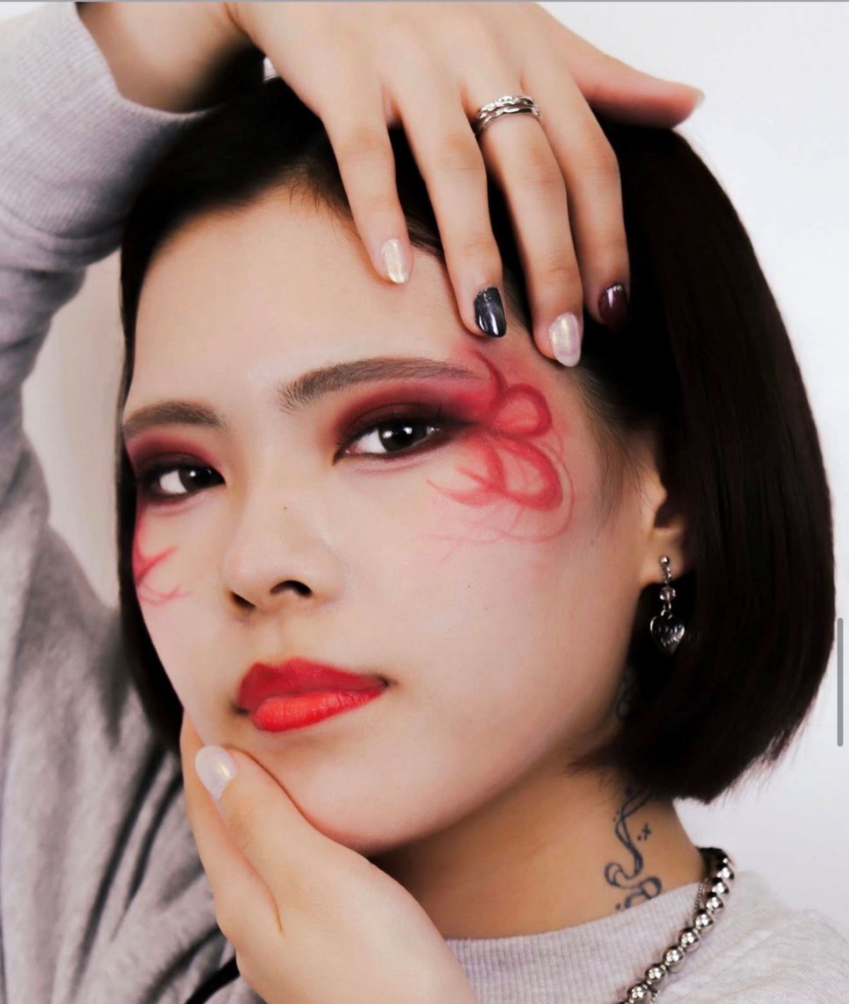 Young woman shows off face art close to her left eye