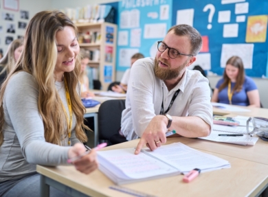 A Level Philosophy tutor is explaining some notes to a student