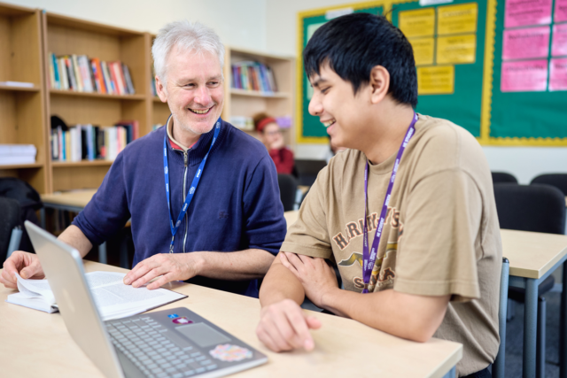 Tutor and student discuss work in front of a laptop Access Humanities