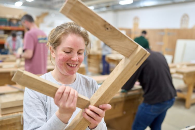 A student craft some wooden furniture