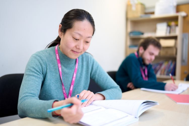 A student reads through her work