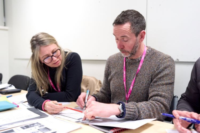 Two students work together while learning Italian