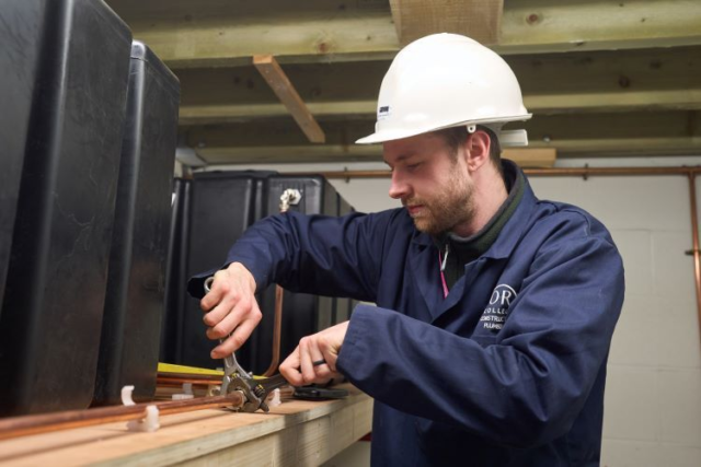 A student works on some piping