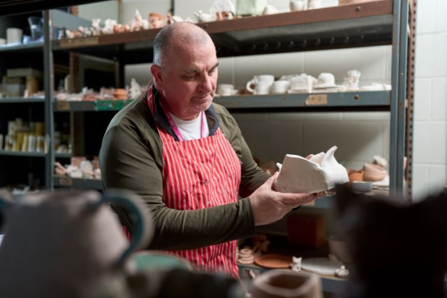 A student studies some pottery