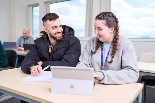 Access Health two students smile and work