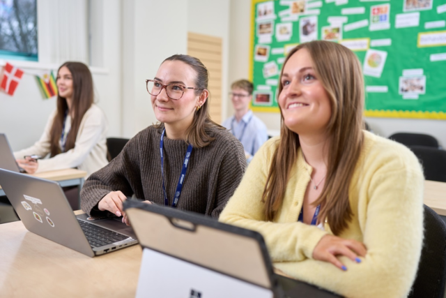 Two students smile at their tutor CIPD