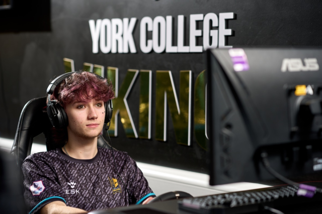 A student looks at a computer screen Esports