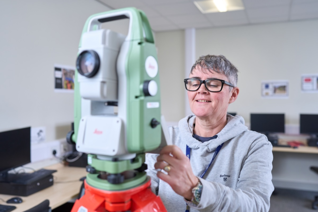 A student looks at some surveying equipment Construction