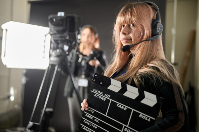 A student holds a clapperboard Film