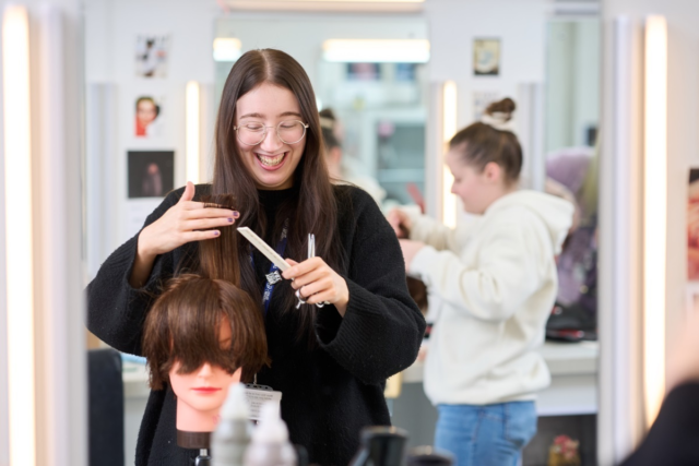 A student cuts a wig Media Makeup