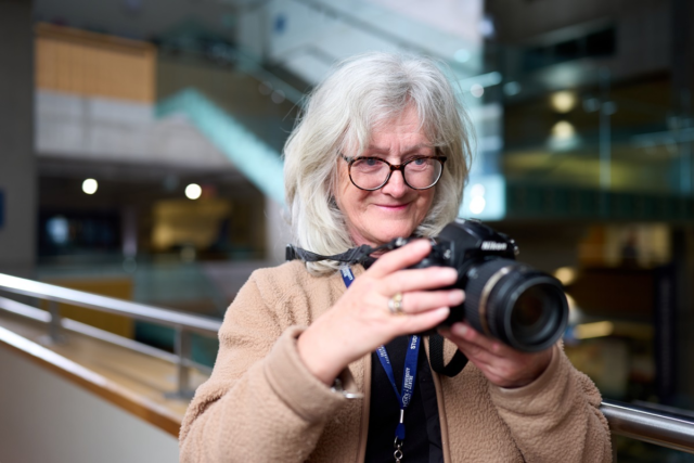 A student points a camera Photography 2